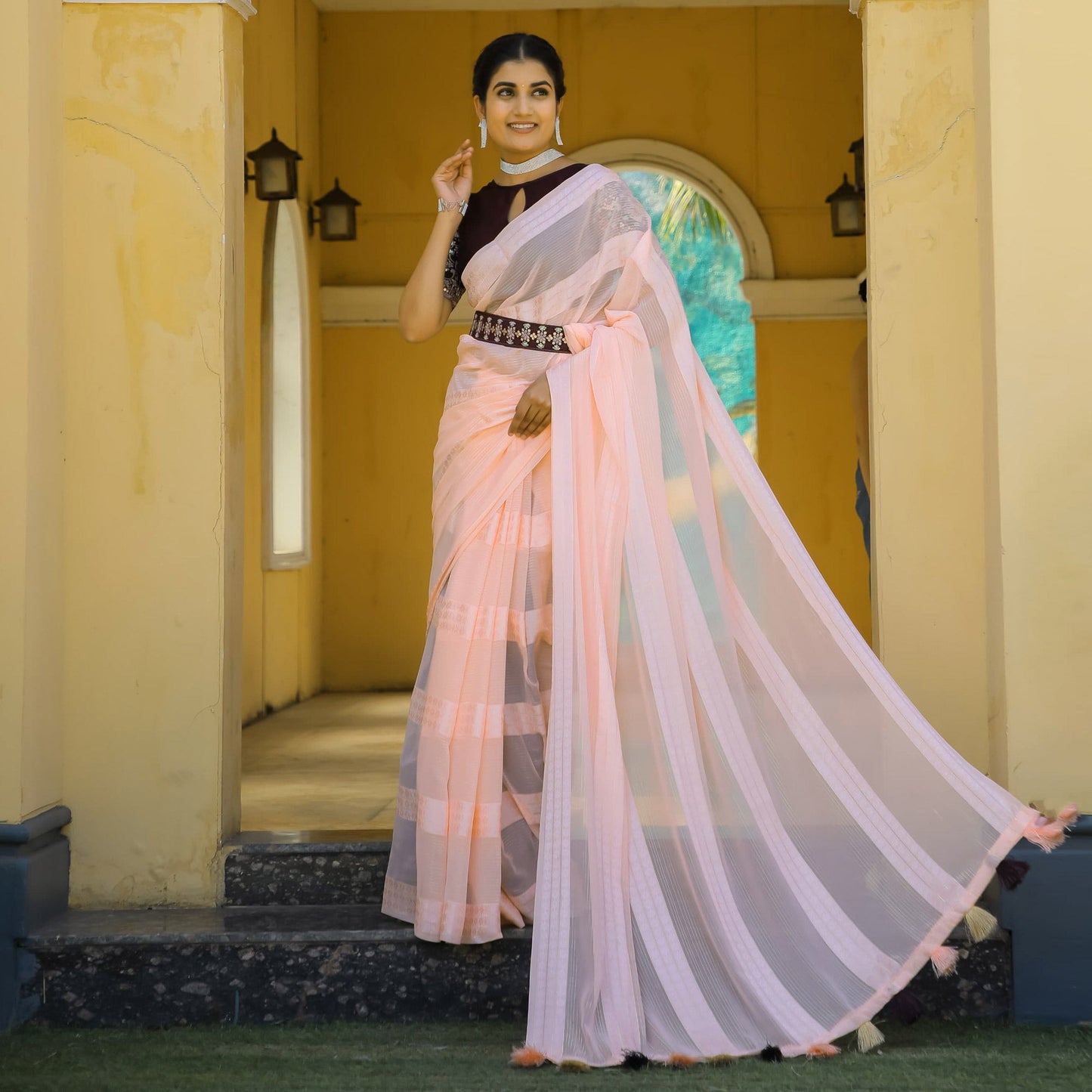 Light Peach Zari Woven Georgette Saree With Tassels